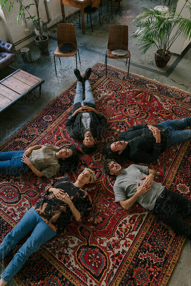 Five People Lying on Carpet During Group Therapy