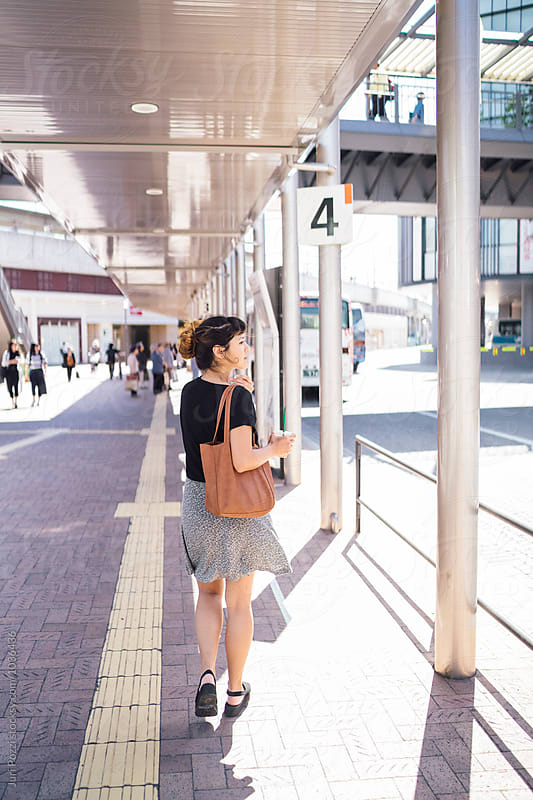 Japanese young woman at a bus stop in Japan