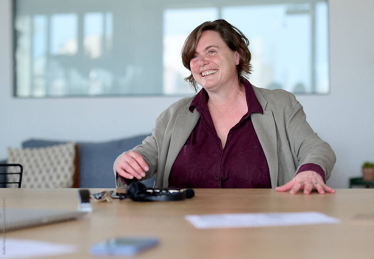 Cheerful mature businesswoman in boardroom