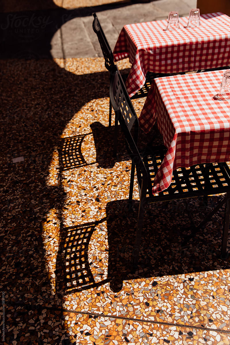 Red and white checkered tablecloths at a cafe in Italy