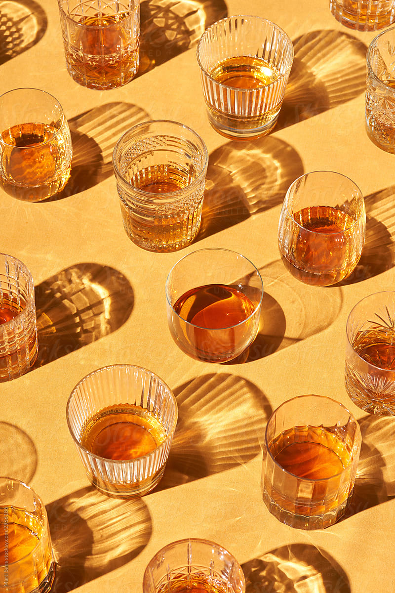 Various glass cups with whiskey