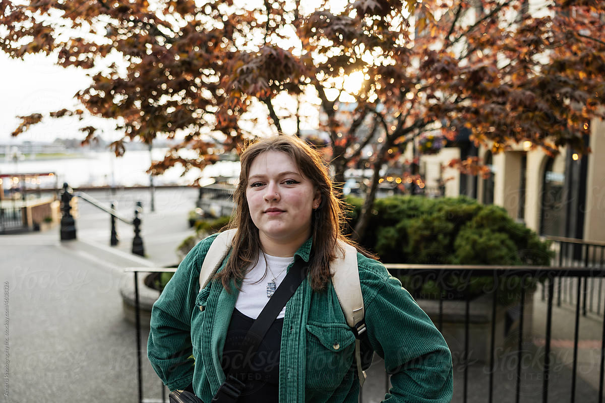 Portrait of young person outside in city.