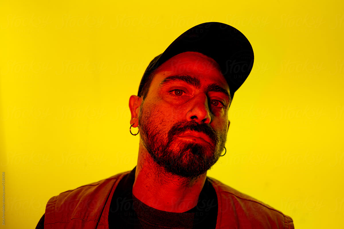 Portrait of a man with red and yellow neon lights.