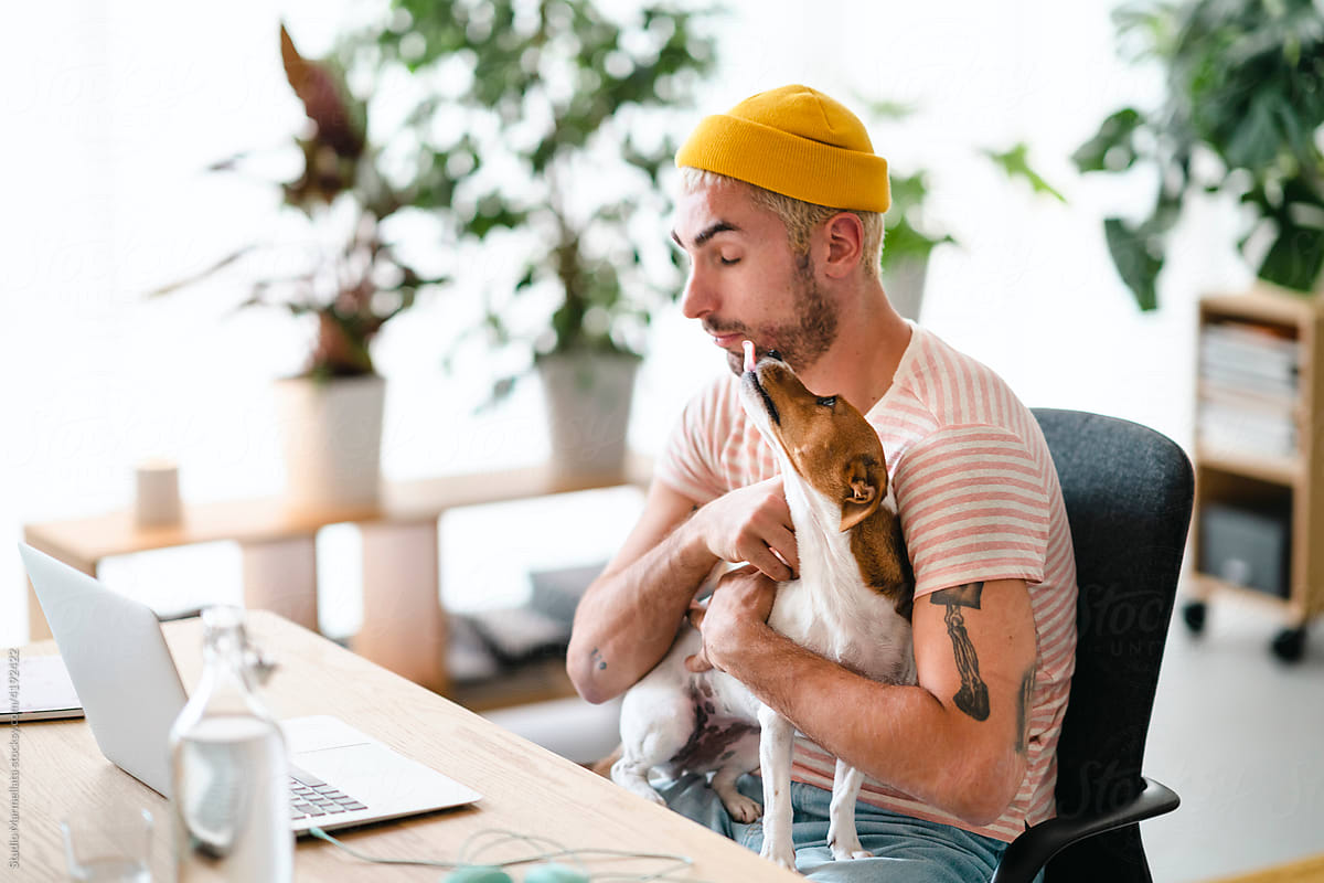 Man with dog in home office