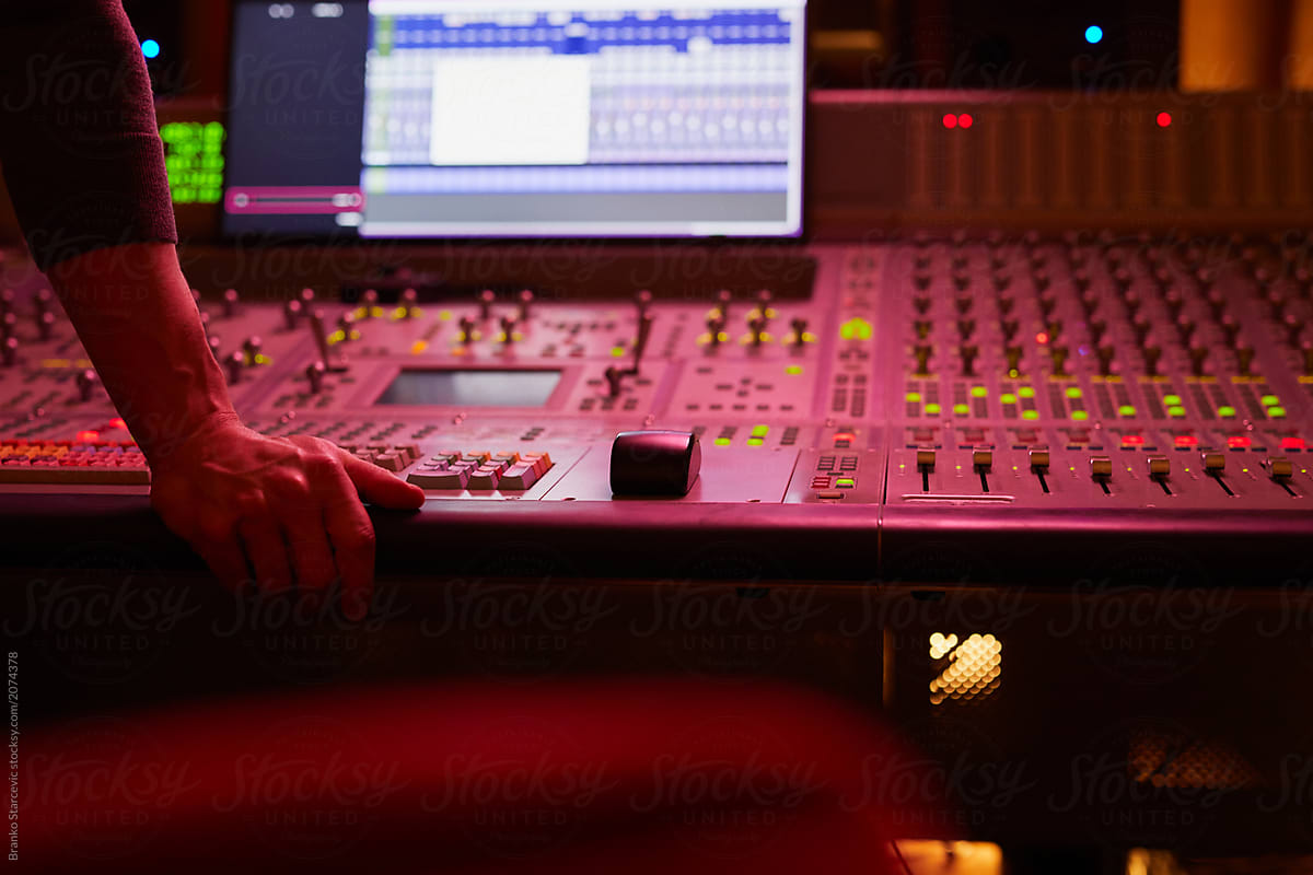 Sound Engineer mixing tracks in studio.