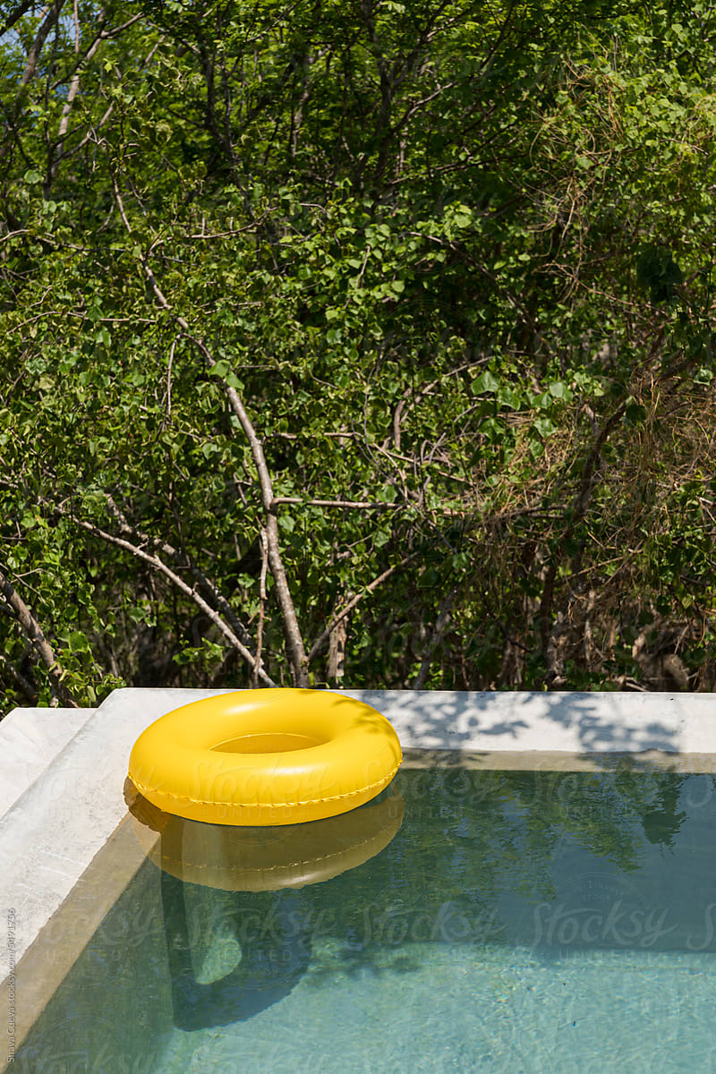 A yellow inflatable in the corner of a blue pool