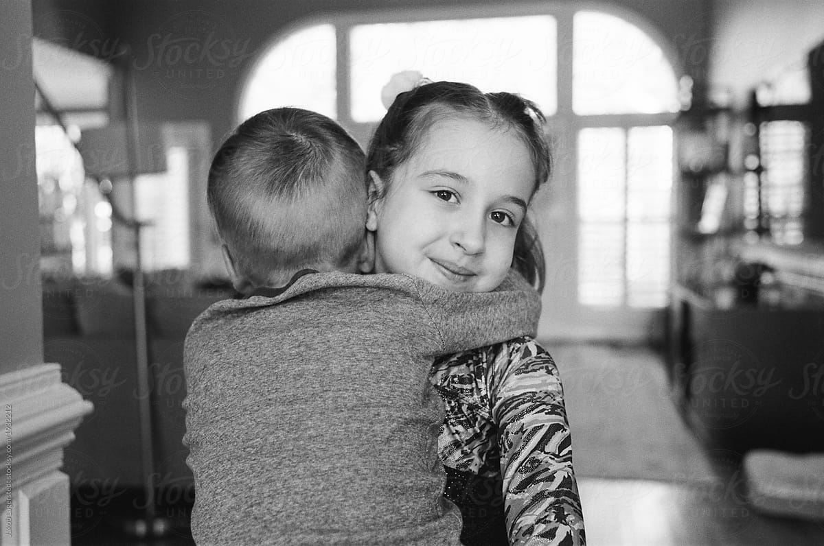 older brother and sister hugging