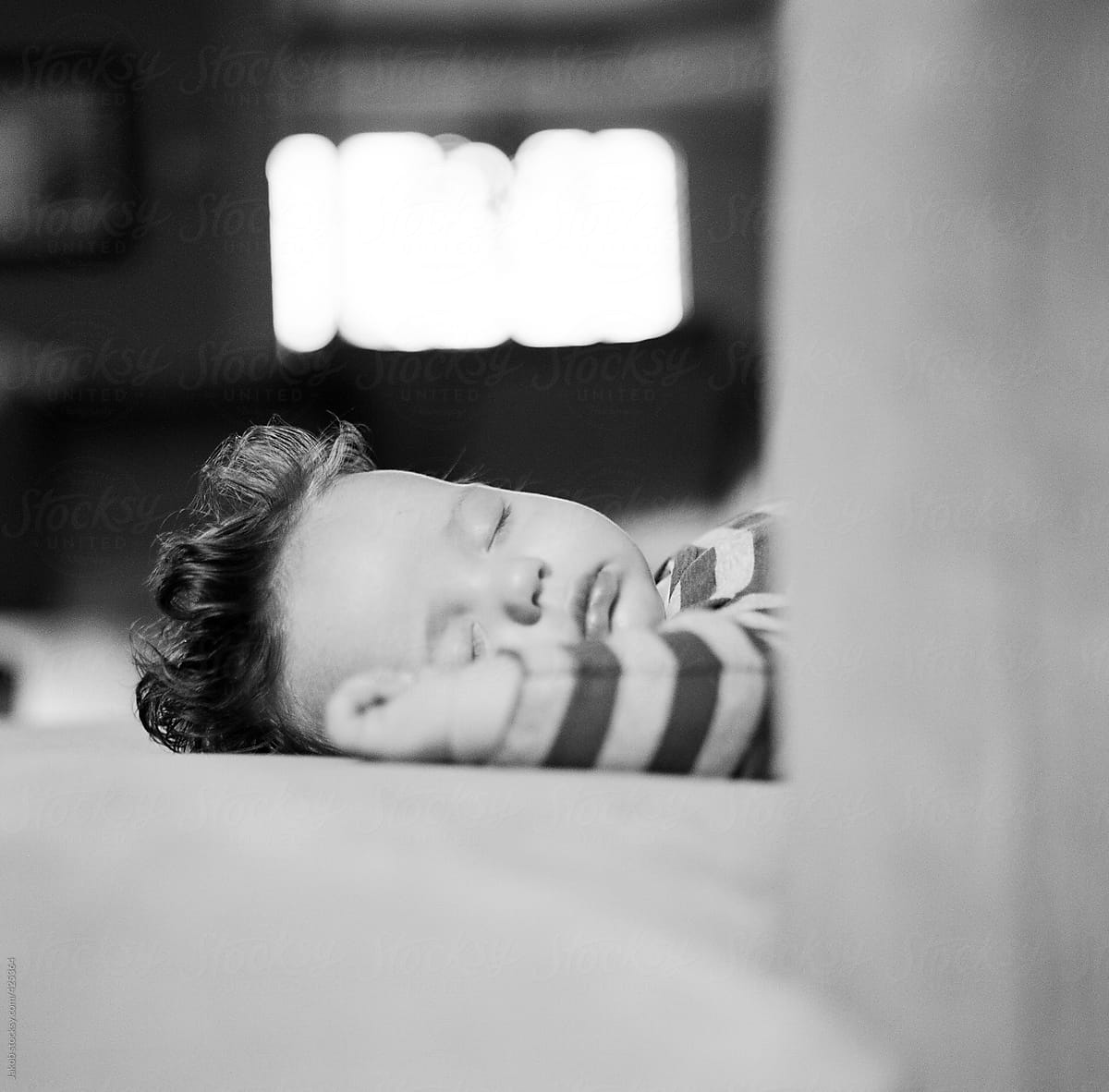 Infant boy sleeping on couch