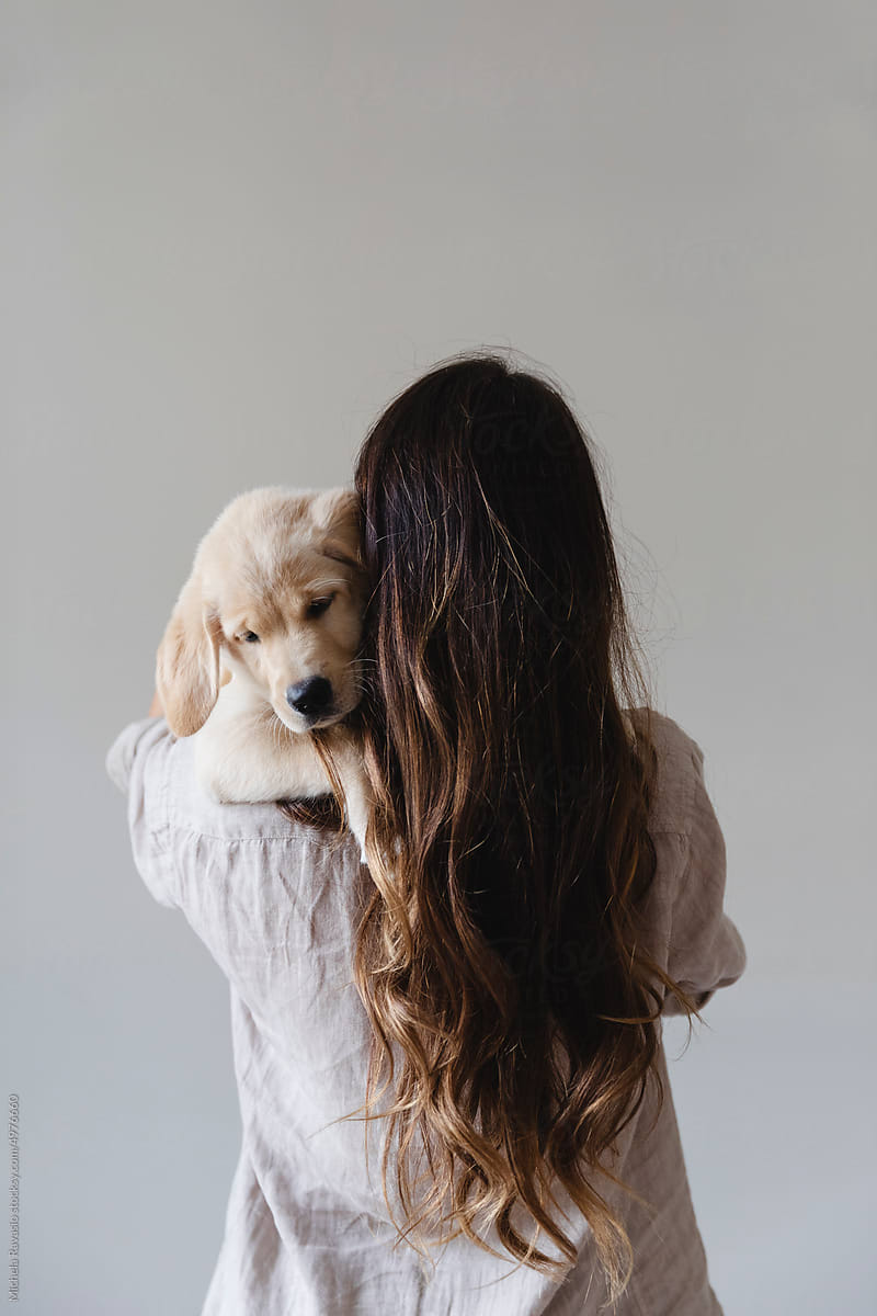 Woman from behind with puppy