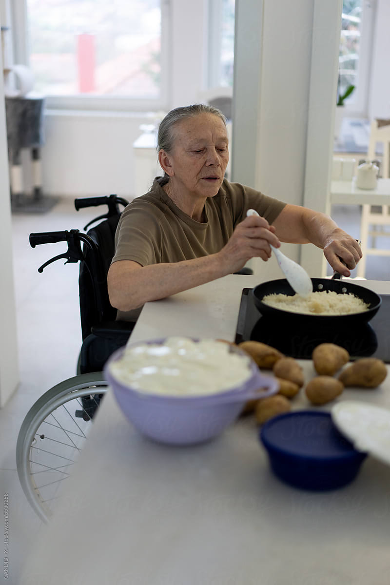 Senior Lady in Wheelchair Cooking