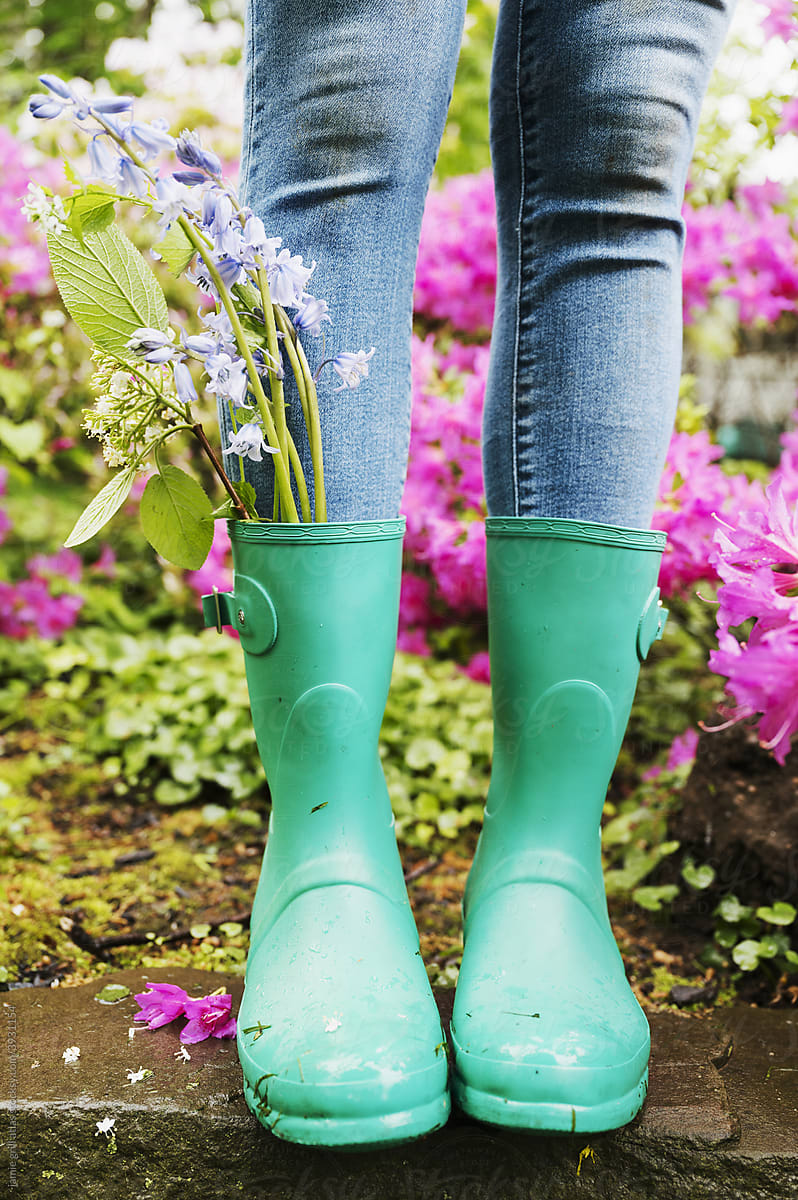 Bunch of Flowers in a Woman\'s Rainboot