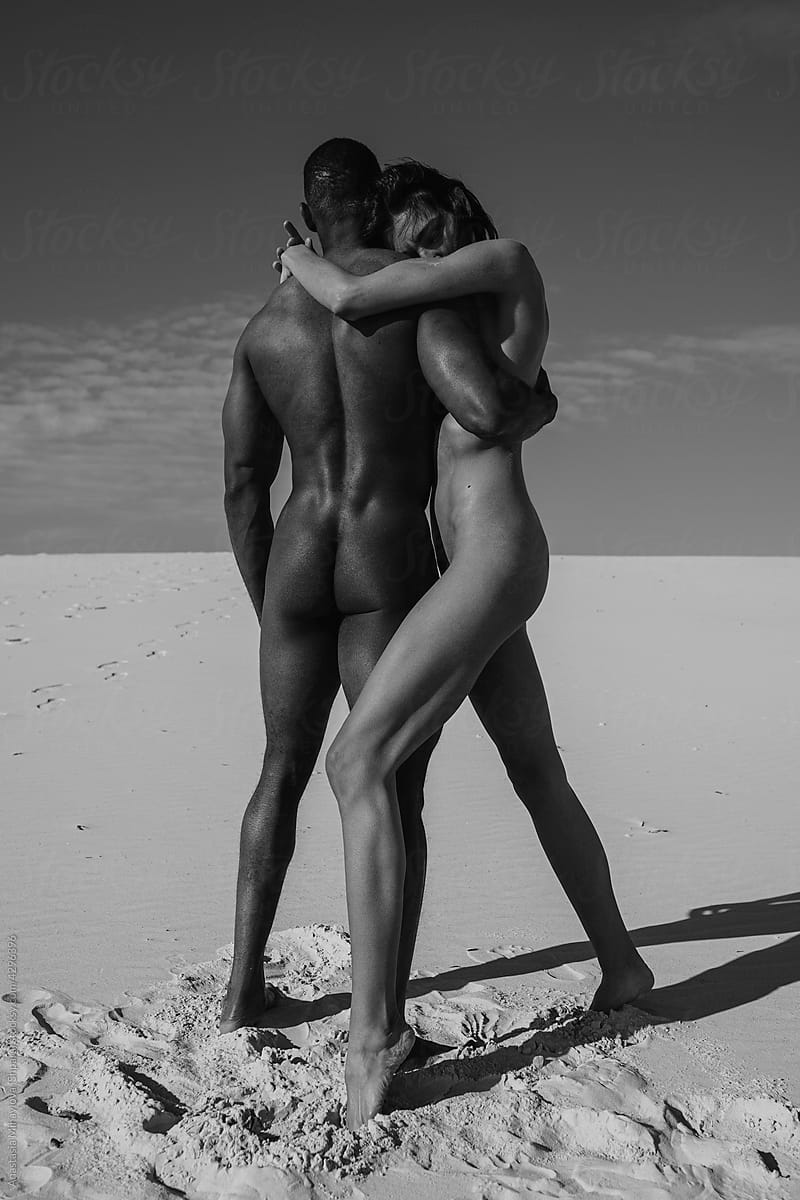 Nude couple in love in the desert monochrome photo