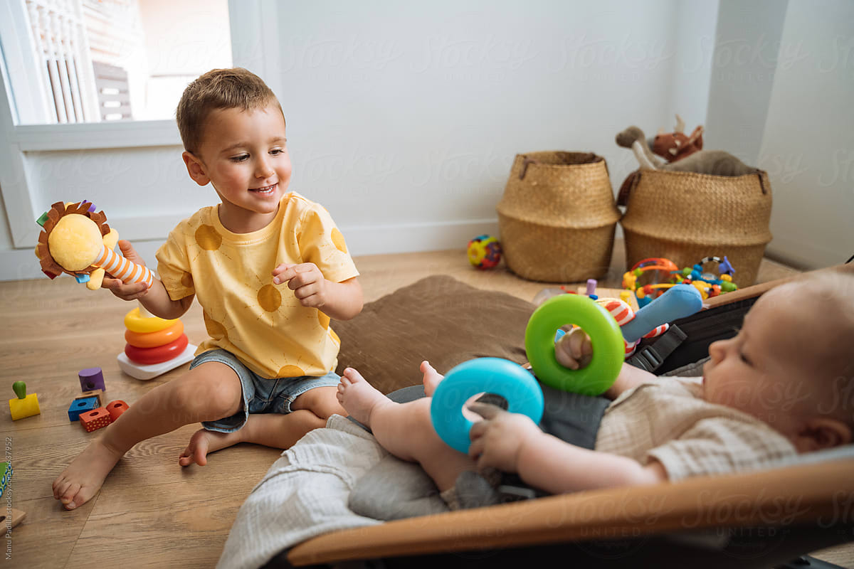 Adorable children with toys in playroom