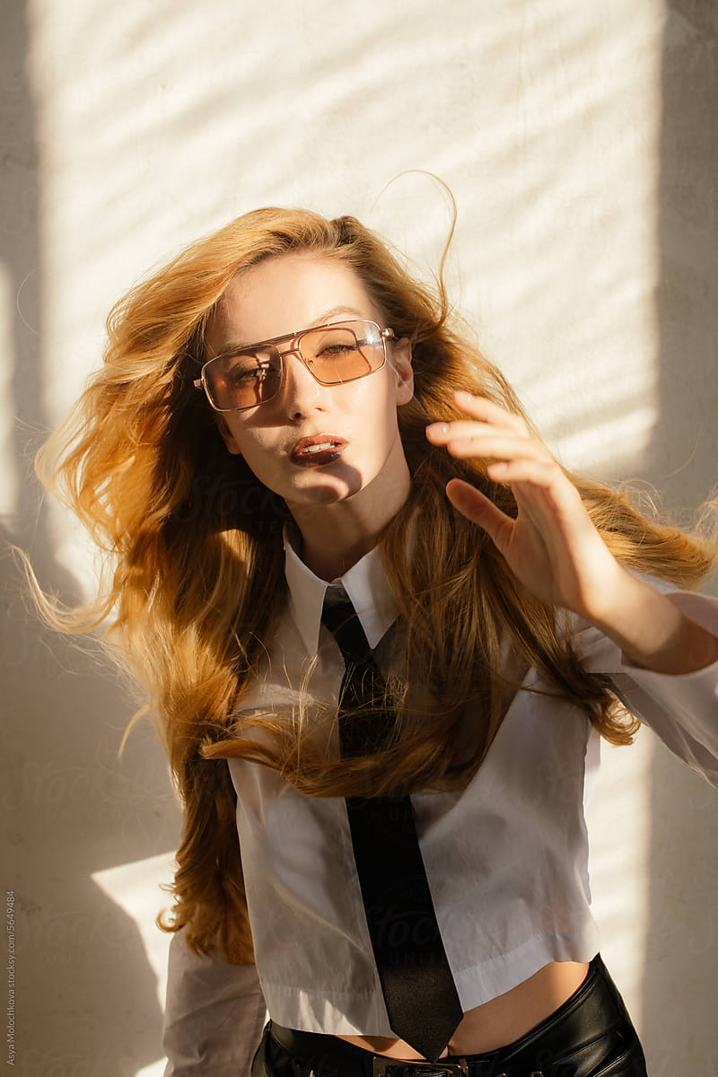 Sunny cool portrait of blonde young woman in studio
