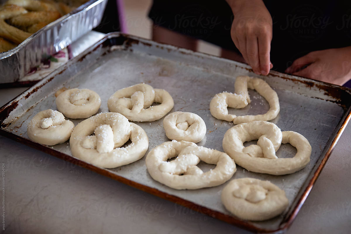 Raw unbaked pretzel dough placed on a  baking sheet