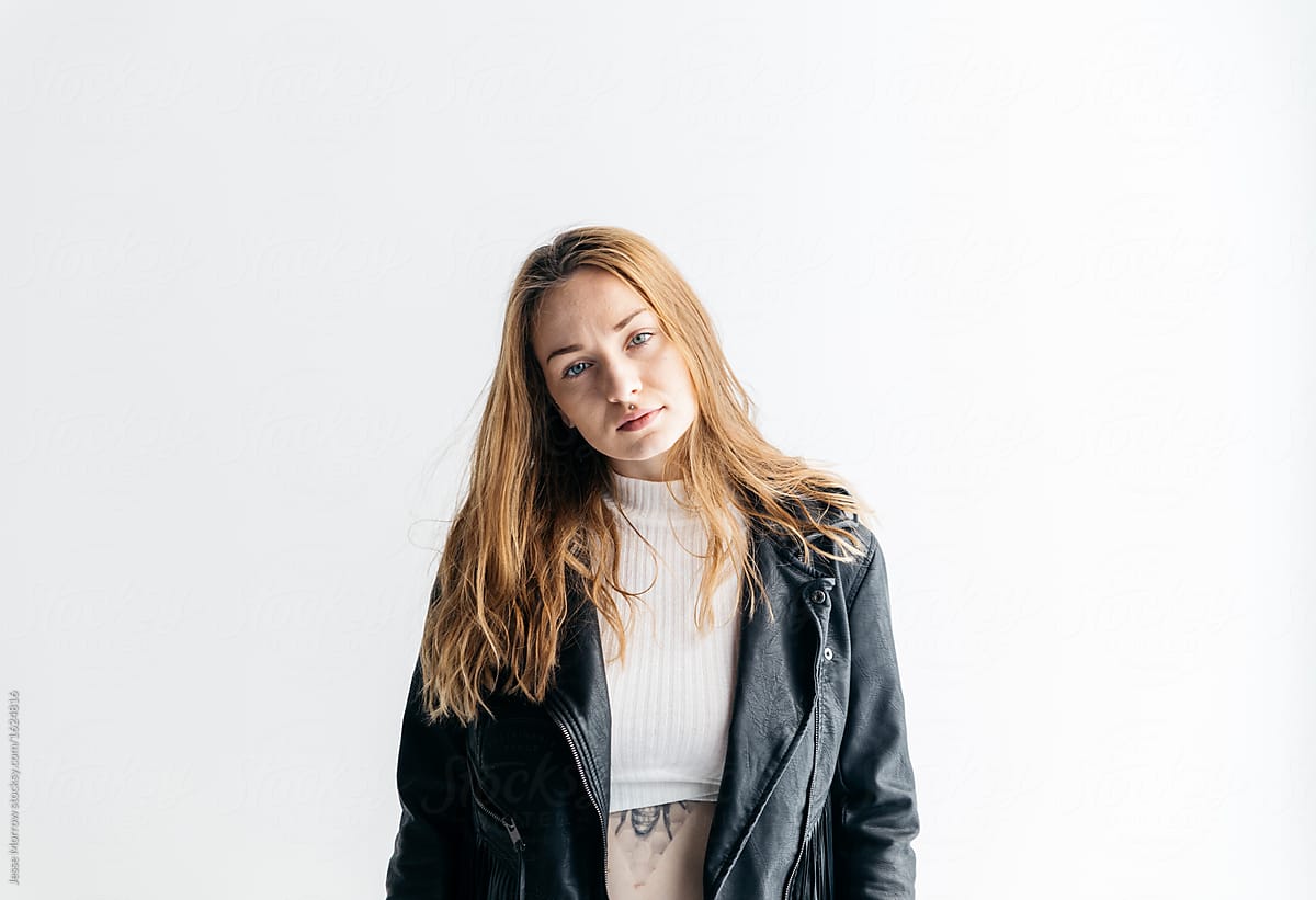 1200px x 821px - Portrait Of Young Woman In Studio Wearing Leather Jacket With Fringe On  White Background.\