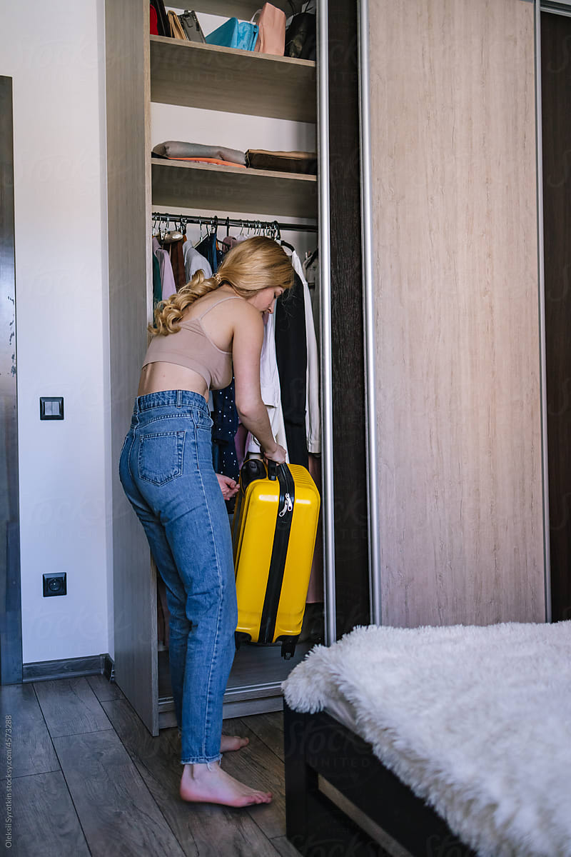 Woman preparing luggage for trip