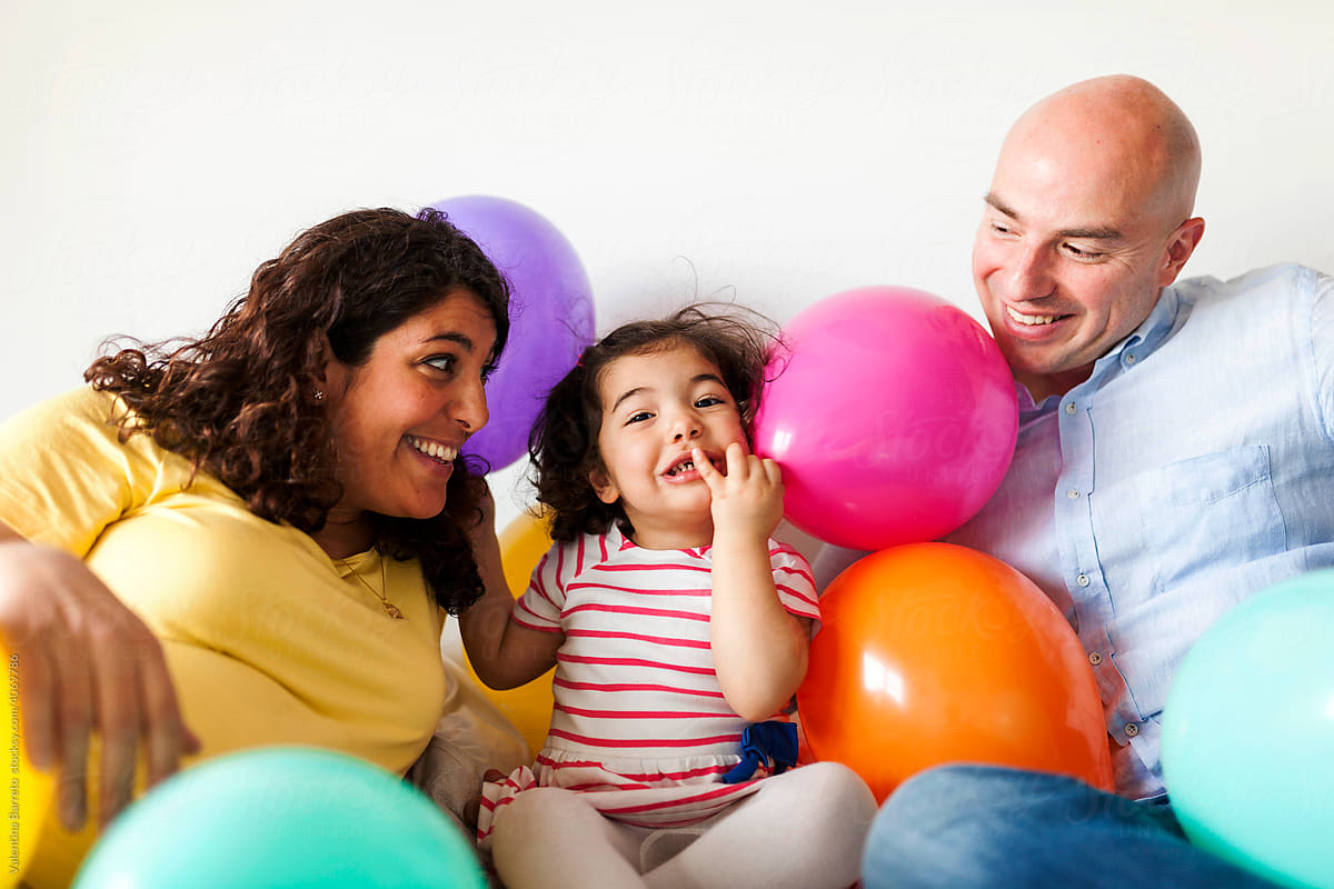 playful family playing with balloons