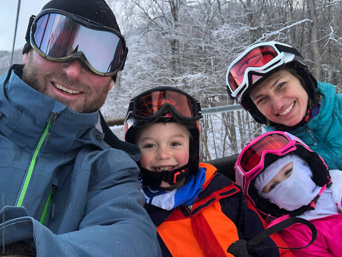 User-generated Content Family selfie portrait in winter while skiing