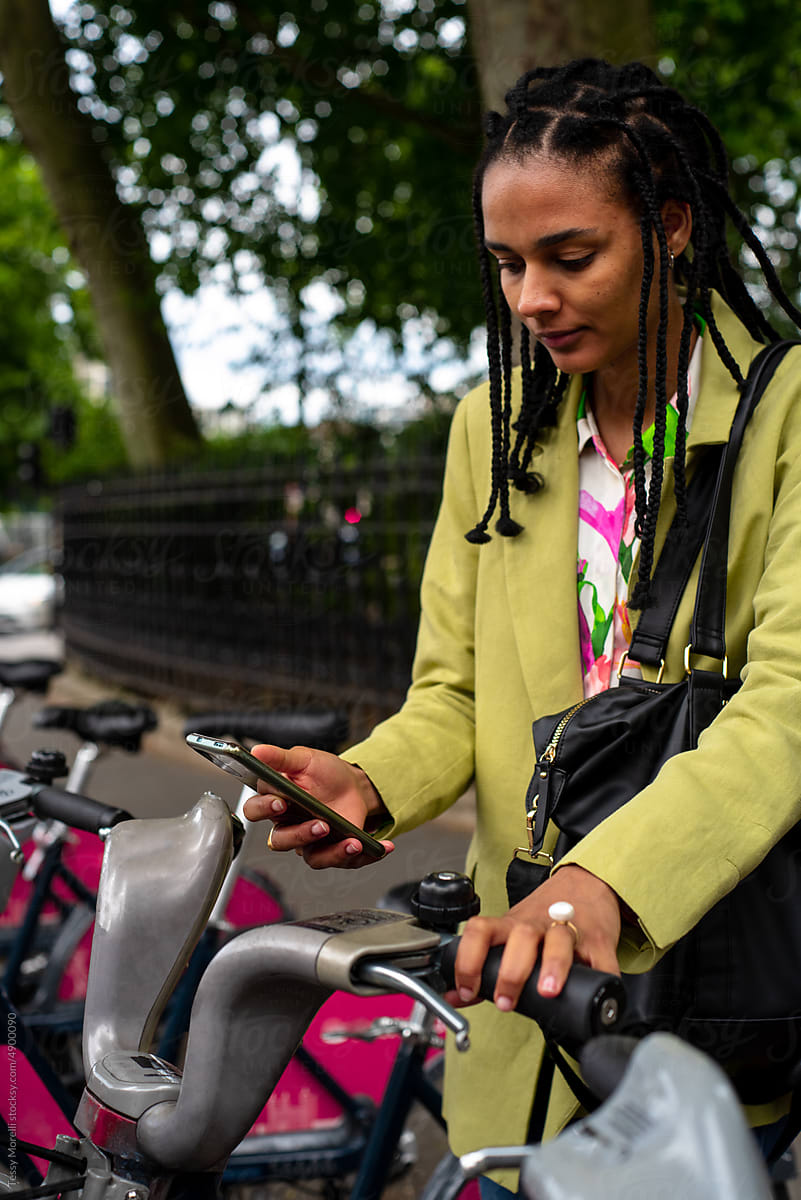 Woman with device unlocking rental bike app