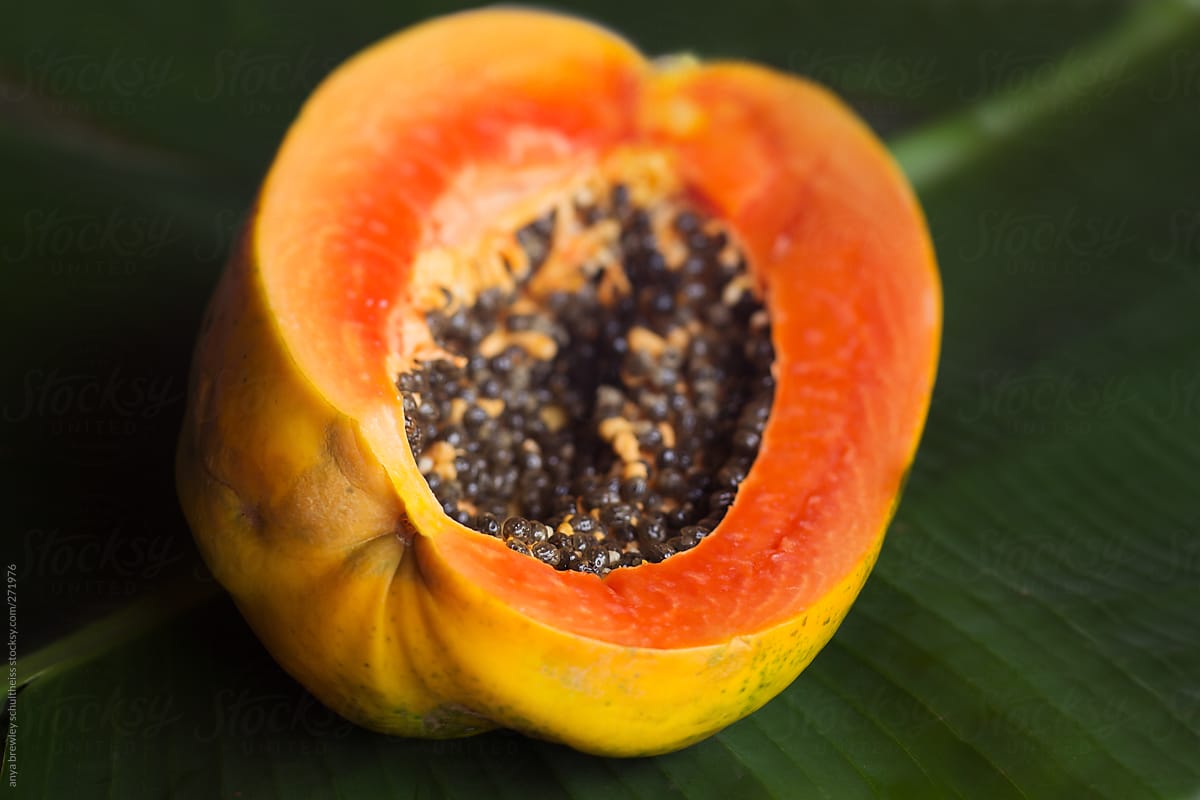 Cut open ripe papaya fruit with seeds