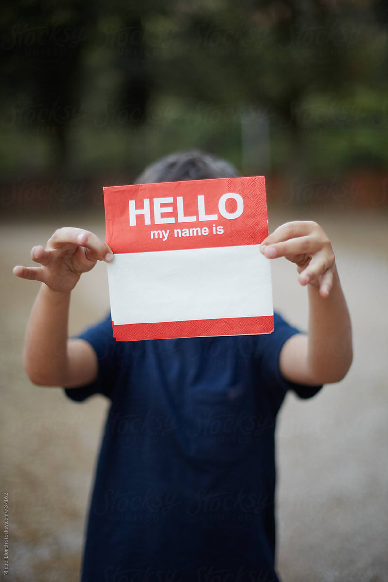 Young kid holding a napkin with the words hello my name is