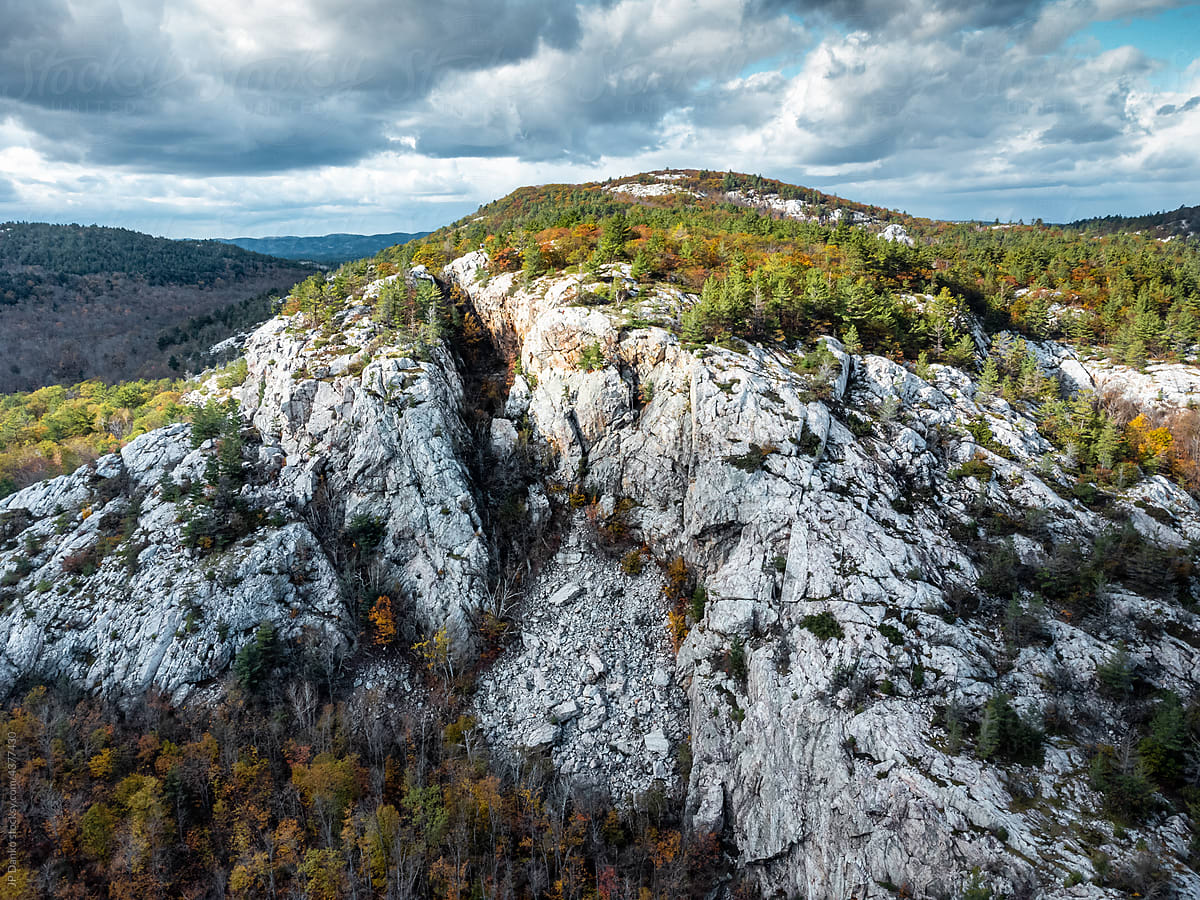 Rocky Mountain Cliff with Autumn Forest