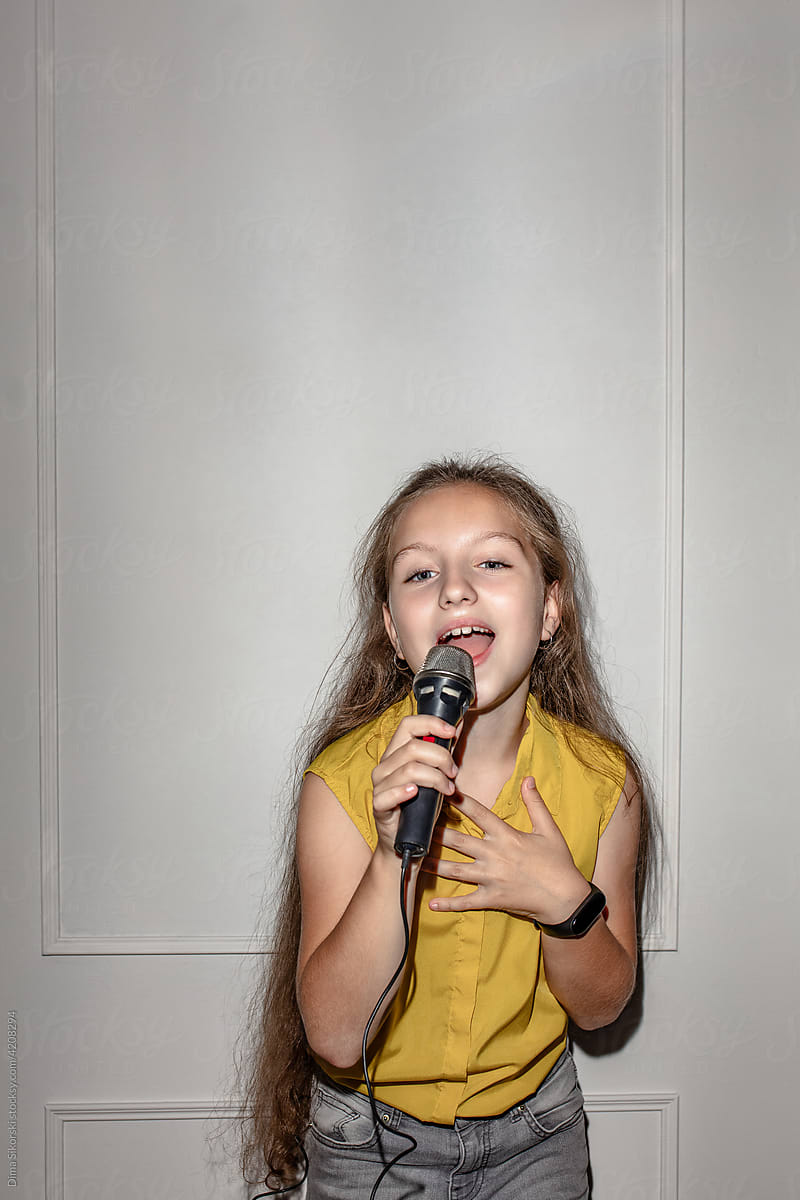 a child sings with a microphone
