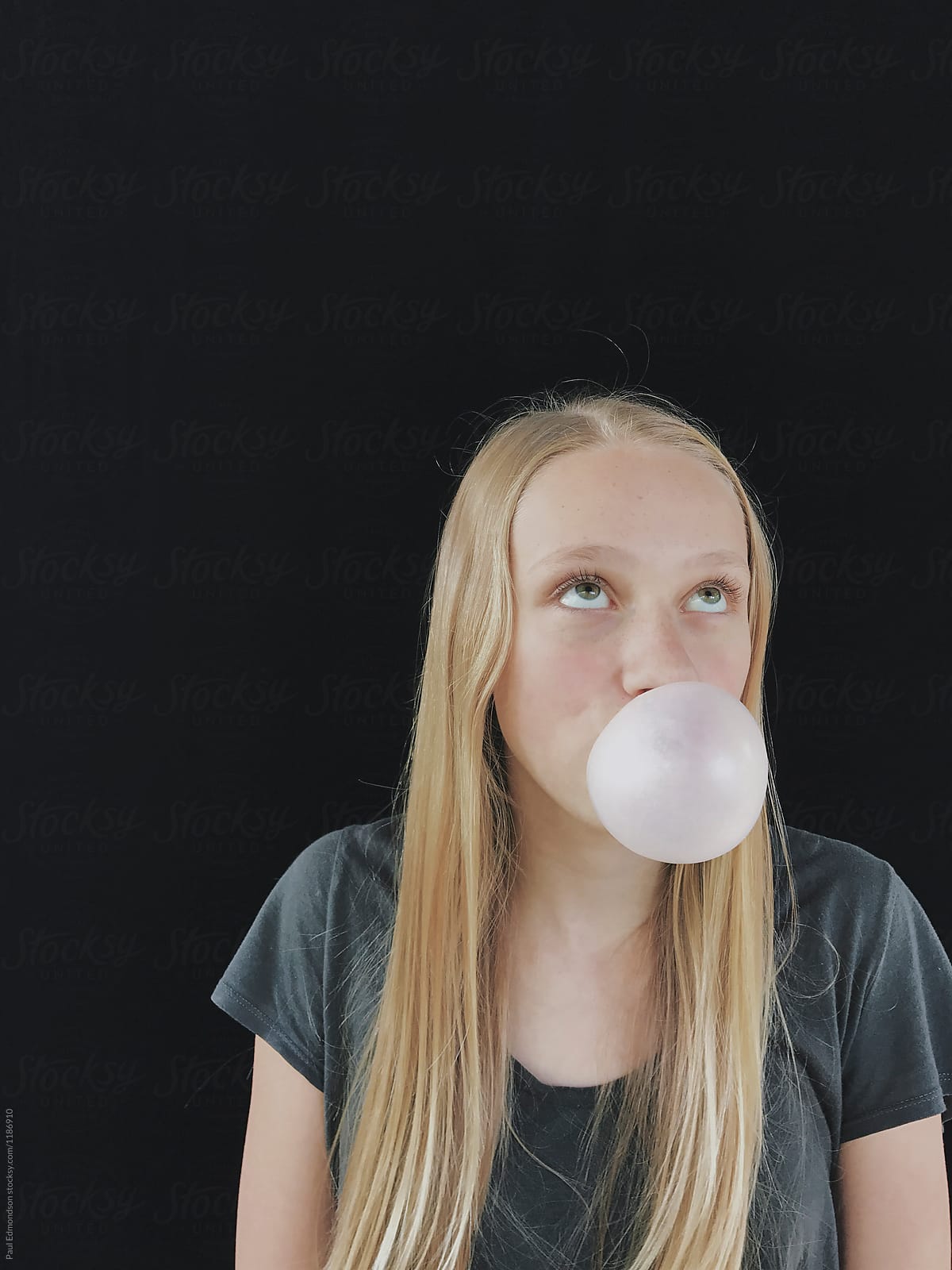 Teenage Girl Blowing Bubble Gum Bubble By Rialto Images 