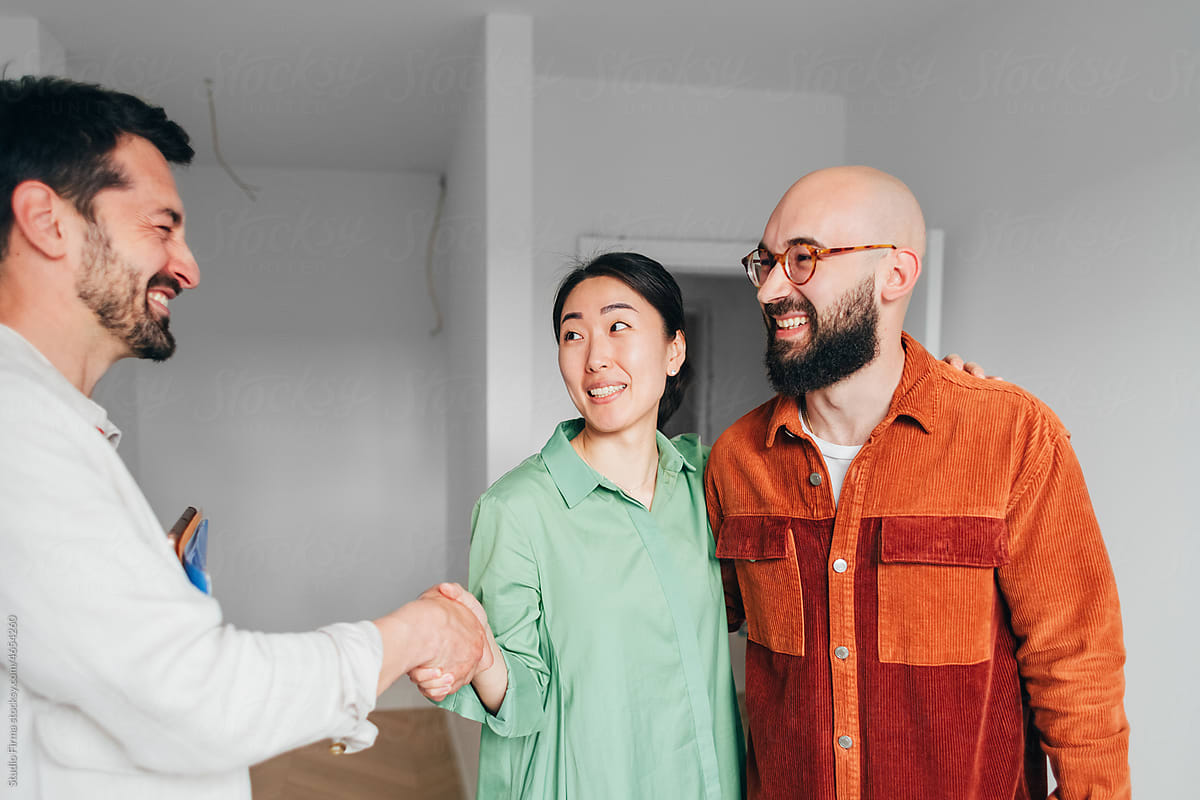 Real Estate Agent Shaking Hands with Clients