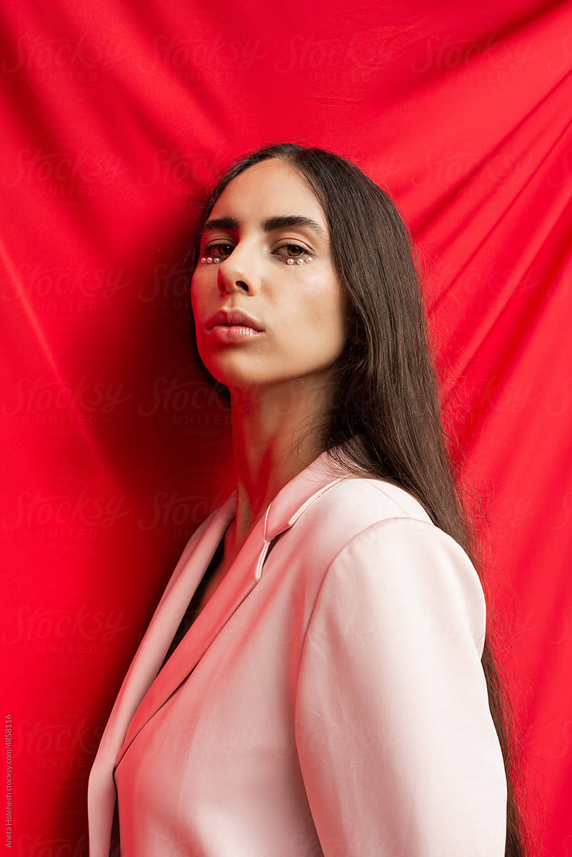 Half portrait of female model in pink jacket