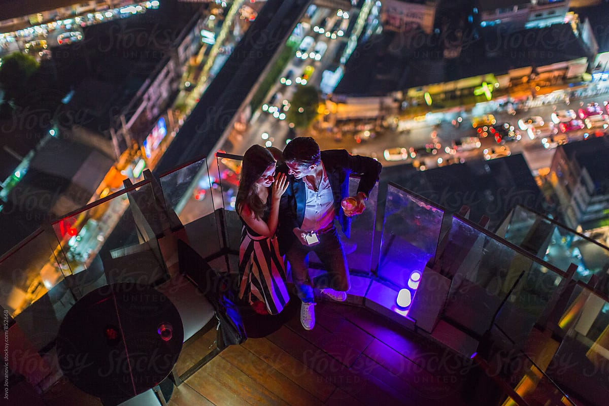 Aerial view of a stylish couple on a date in city at night