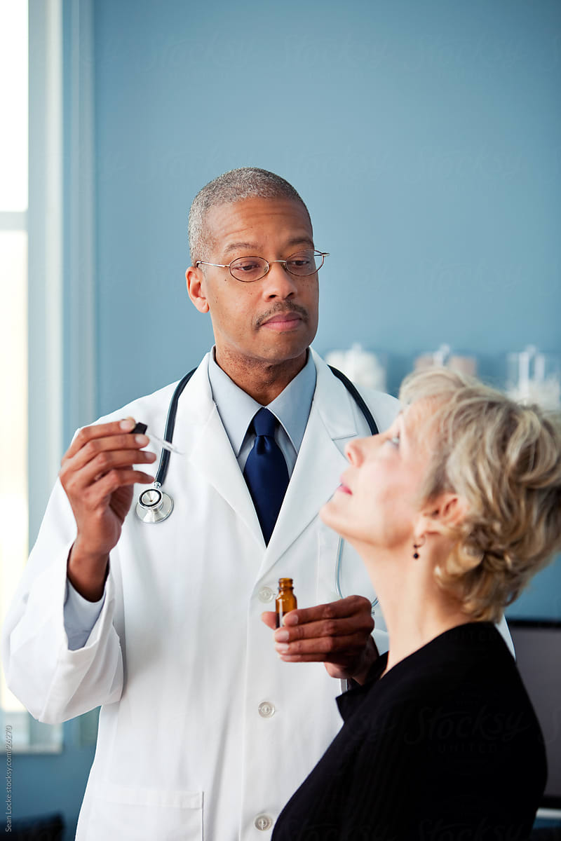 Exam Room: Doctor Ready to Administer Eye Drops to Mature Woman