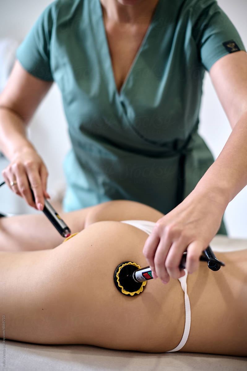 Doctor making body treatment for client