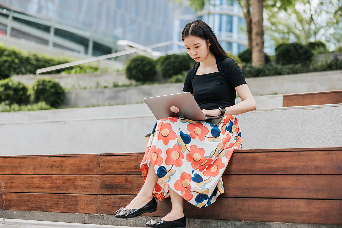 Businesswoman  working on a laptop outdoor