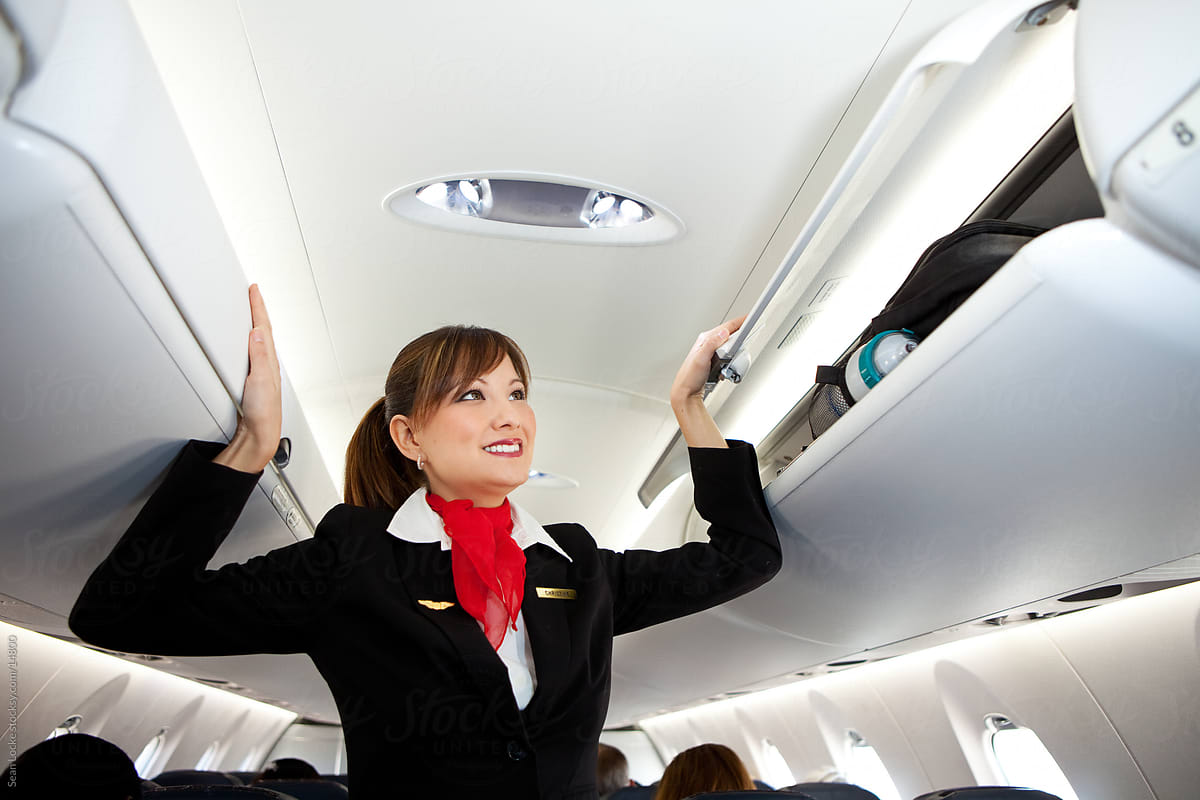 Airplane: Stewardess Closes Compartments Before Take Off