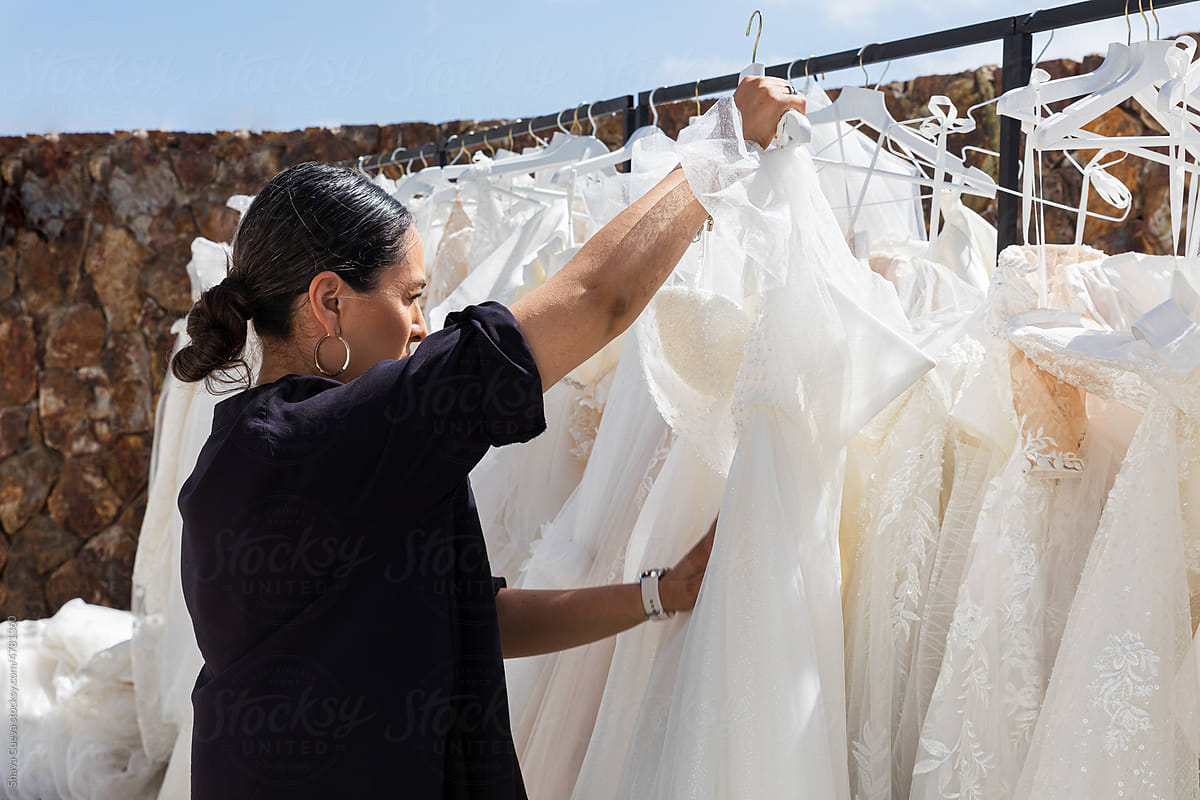 Woman choosing a wedding dress on a rack