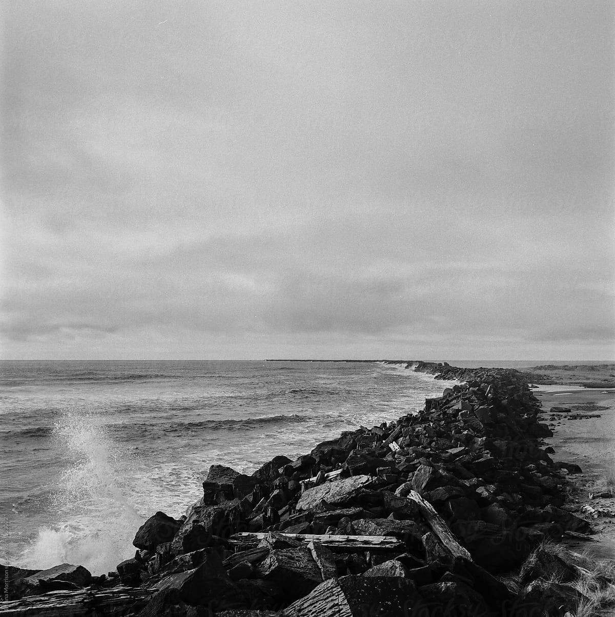 The Pacific Northwest Ocean and A Stone Jetty in Black and White
