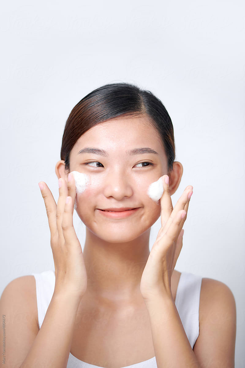 woman wash face with cleansing foam