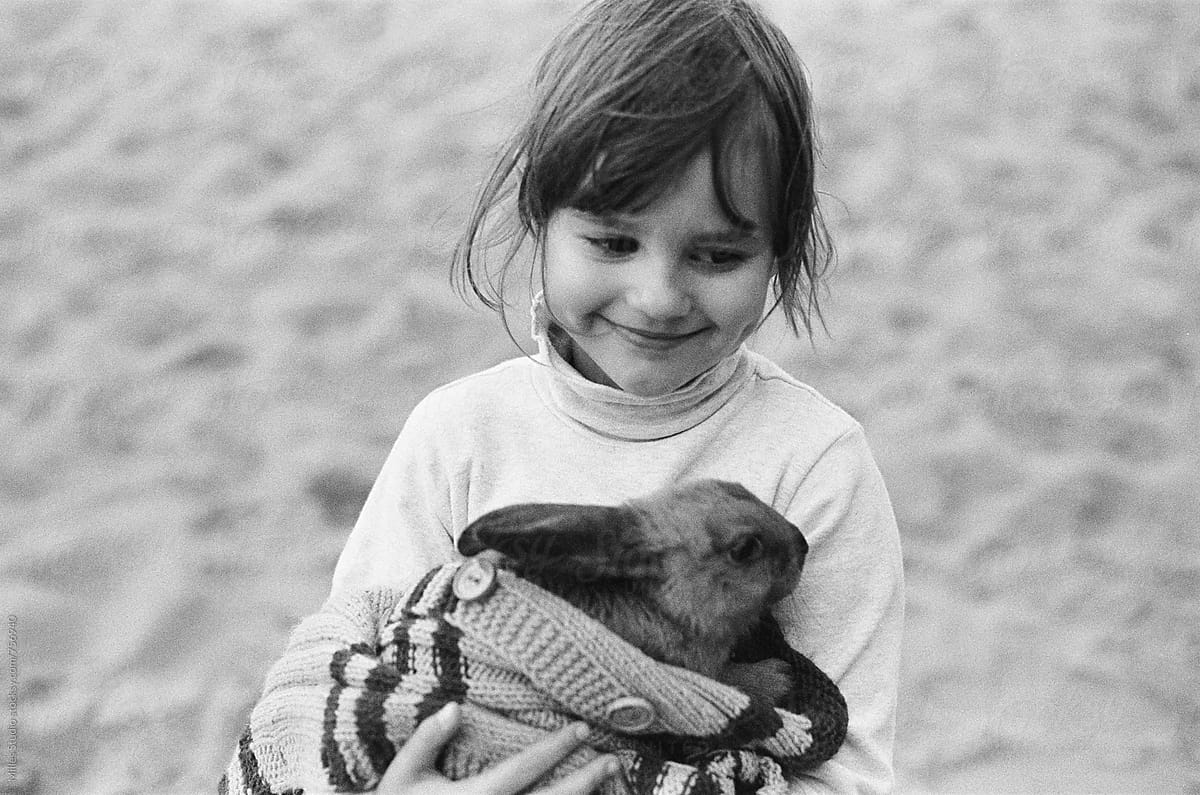 Little girl holding her rabbit