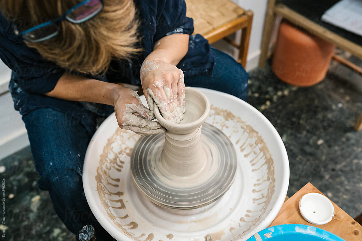 Crop potter making vessel in workshop