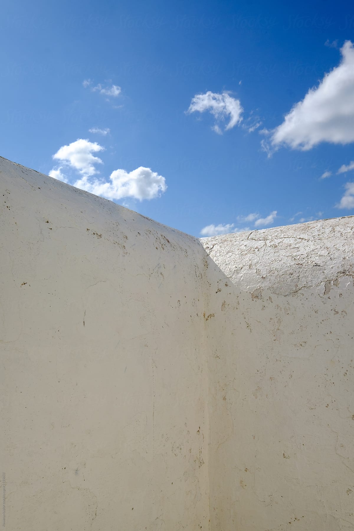 Large white wall against a blue sky