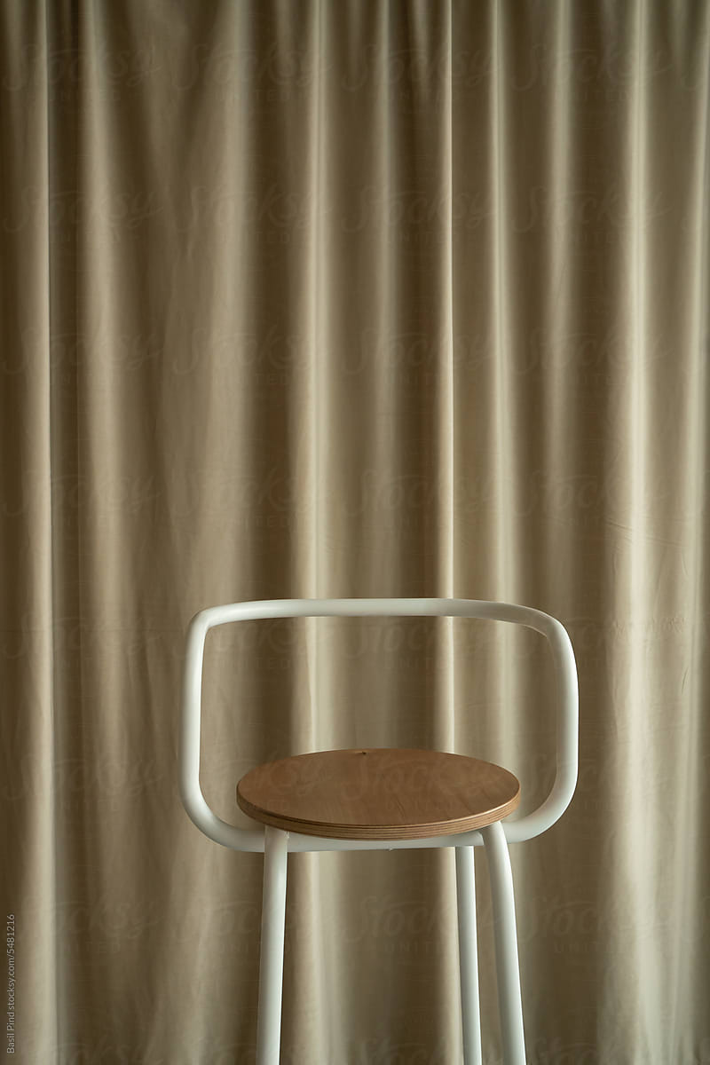 bar stool against a textile velvet curtain