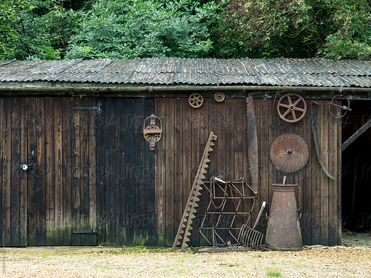 Old wood sawmill with rusted tools on the wall