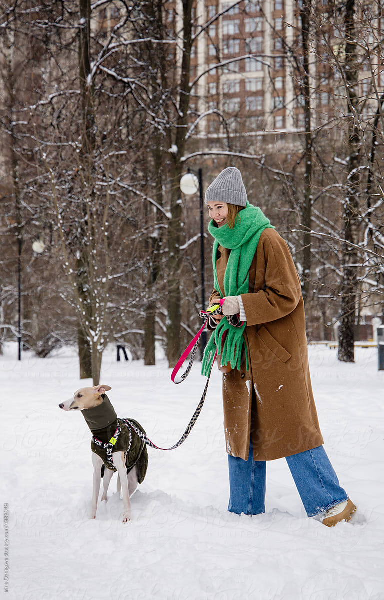Woman walking with dog in winter