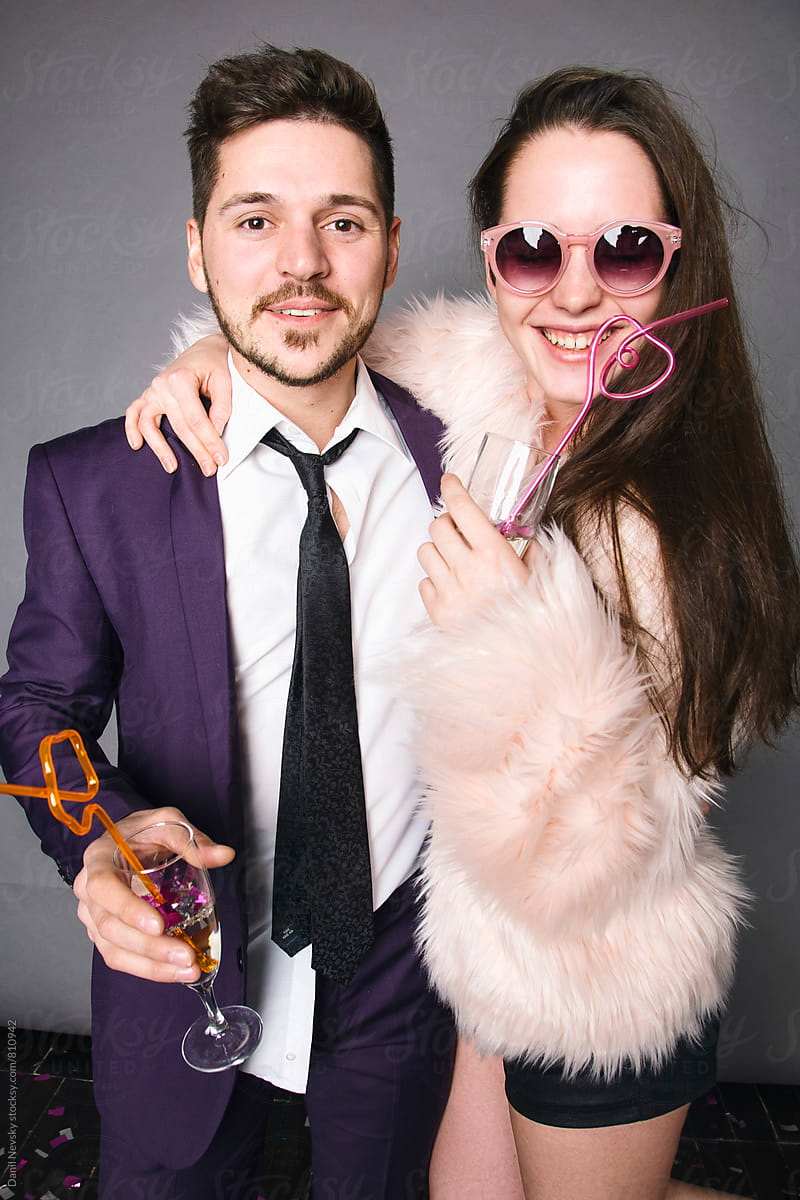 Photo of beautiful young couple holding glasses of champagne