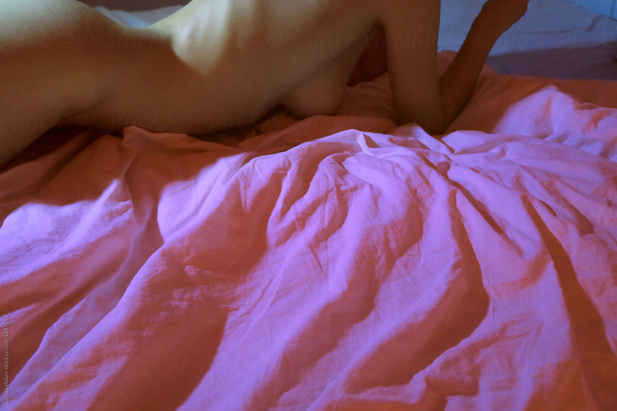 naked in pink bed with copyspace