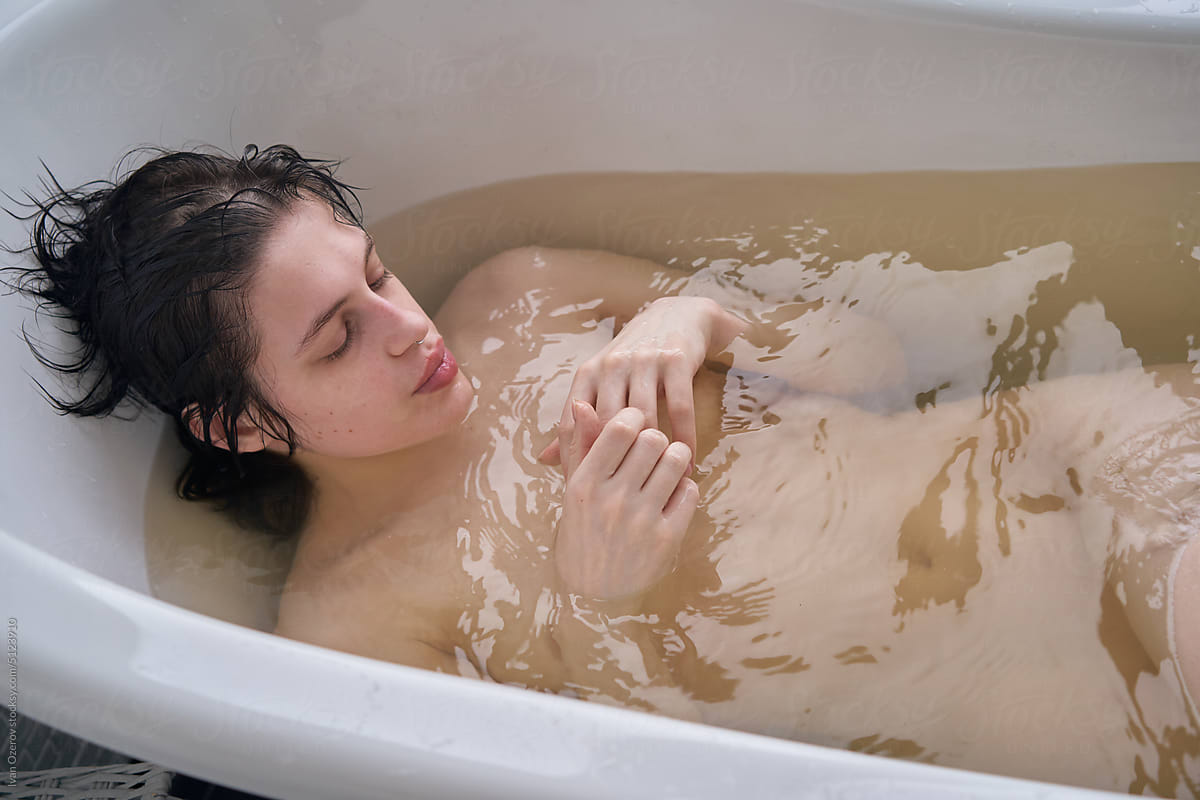 Young brunette lying in dirty water