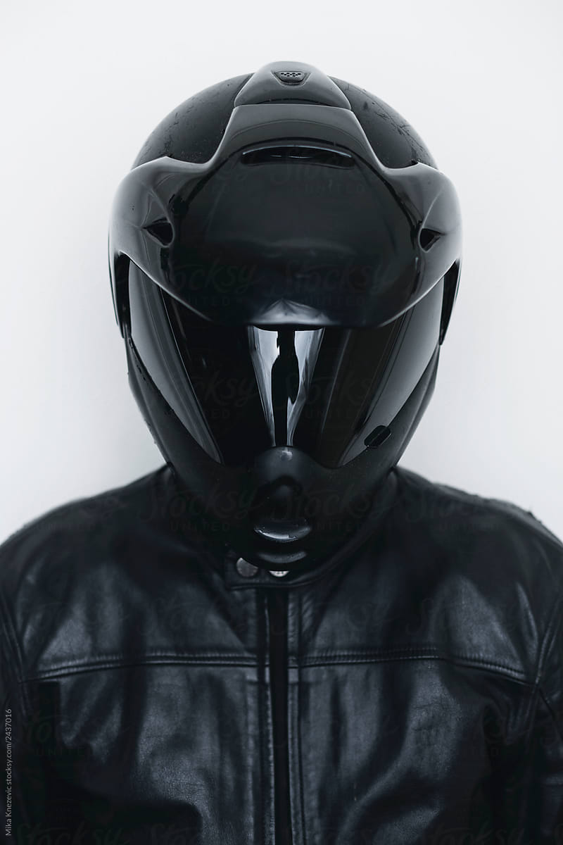 Biker with black leather jacket and black helmet