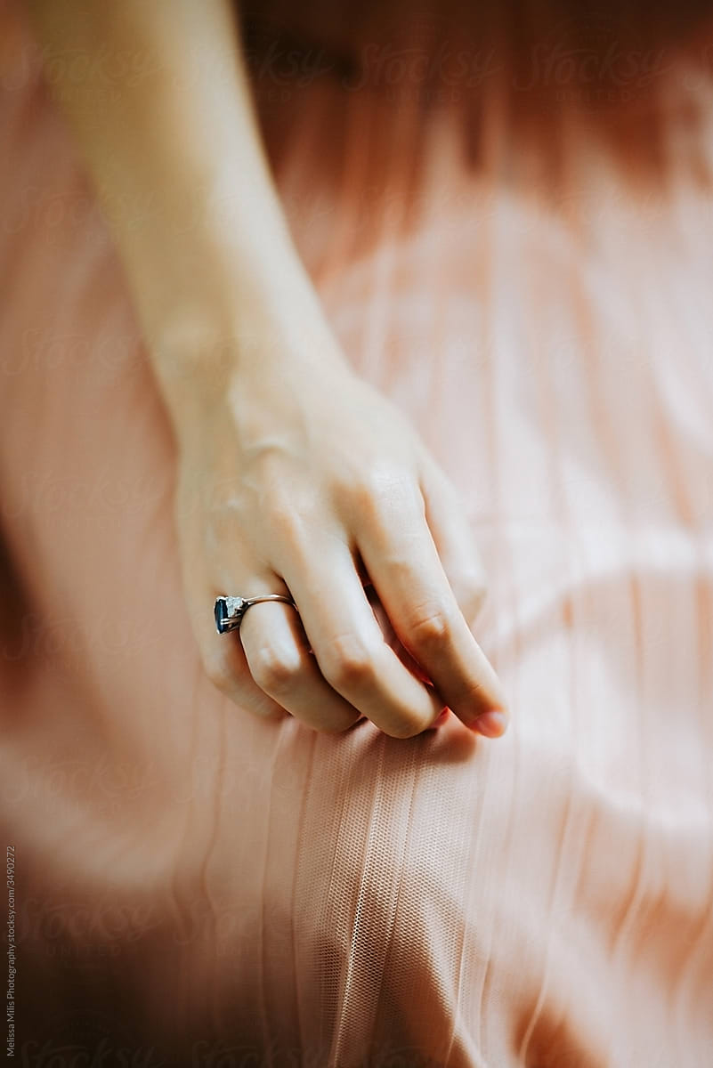 close up of female hand wearing an engagement ring